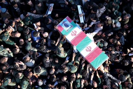 Iranian civilians and members of its armed forces carry the flag draped coffin of Brigadier General  Hamid Taqavi, a senior Revolutionary Guard commander, who was killed during a battle against Isis.