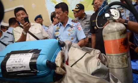 Members of the Indonesian Air Force show items retrieved from the Java sea during search and rescue operations for the missing AirAsia flight QZ8501, in Pangkalan Bun on December 30, 2014 Central Kalimantan, Indonesia.