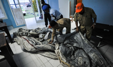 Officers display an object suspected as belongings of AirAsia QZ8501 that found on the sea of Karimata at Pangkalan Bun airport, Central Kalimantan province, Indonesia, on Dec. 30, 2014.