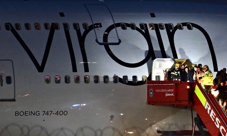 Passengers disembark the Virgin Atlantic Boeing 747 at Gatwick after the emergency landing