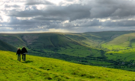 Walkers on Mam Tor with Edale valley and Kinder Scout in the background, Peak District, Derbyshire, UK.