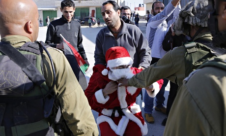 Palestinian protester dressed in a Santa Claus 