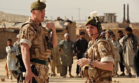 Afghan men watch British soldiers with t