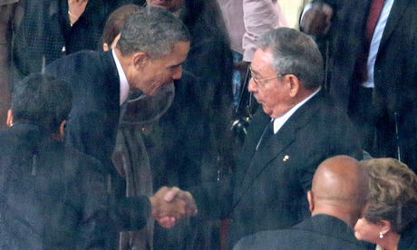 Barack Obama and Raul Castro shake hands at Nelson Mandela's funeral in December 2013.