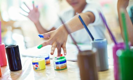 Student finger painting in class