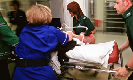 Ambulance crew bring a new patient to an NHS A&E ward