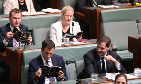 The opposition hold up a booklet titled 