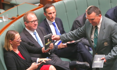 Parliamentary attendants collect “props” from Labor’s David Feeney.