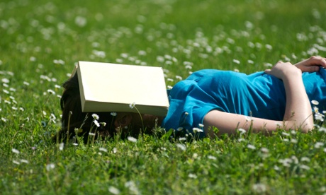 Teenager sleeping with book over face
