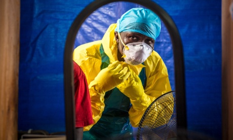 A healthcare worker prepares to enter an Ebola treatment centre west of Sierra Leone's capital Freetown