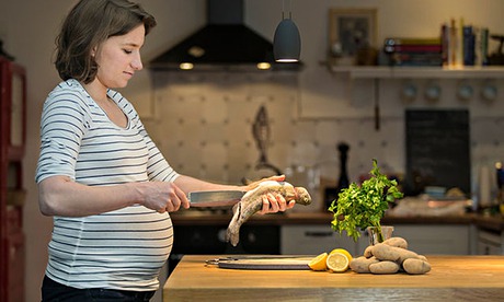 Pregnant woman preparing a meal 