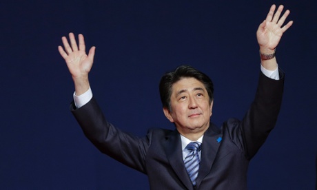 Japan s Prime Minister Shinzo Abe waves to members of the Japanese community during a meeting at the Brazilian Society of Japanese Culture, in Sao Paulo, Brazil.