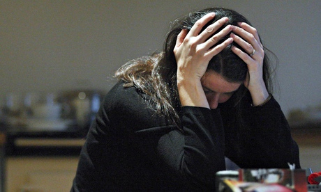 Woman with head in hands