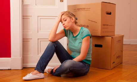 Upset woman with unpacked boxes