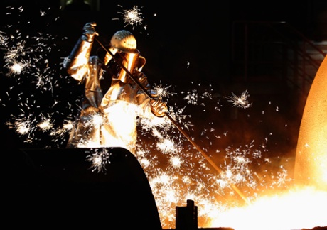 A worker controlling a tapping of a blast furnace at Europe's largest steel factory of Germany's industrial conglomerate ThyssenKrupp AG in the western German city of Duisburg December 6, 2012.