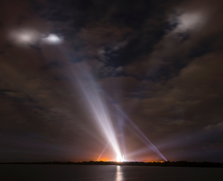 Spotlights illuminate the cloudy pre-dawn sky and Nasa’s Delta IV Heavy rocket sitting on the launchpad.