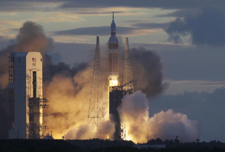 A Nasa Orion capsule on top of a Delta IV rocket lifts off on its first unmanned orbital test flight from Complex 37 B at the Cape Canaveral Air Force Station.