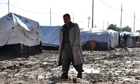 An Iraqi refugee, having fled his home along with many others due to the violence of armed groups le