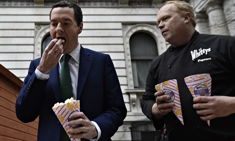 George Osborne samples popcorn during a tour of market stalls promoting the livelihoods of small bus