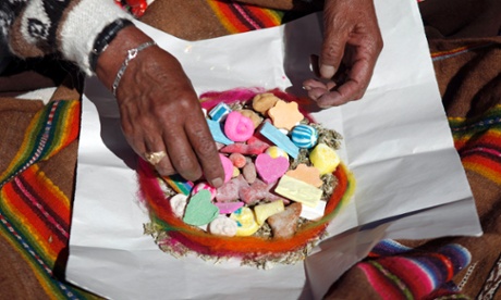 colourful sweets in a bowl being handled by a shaman
