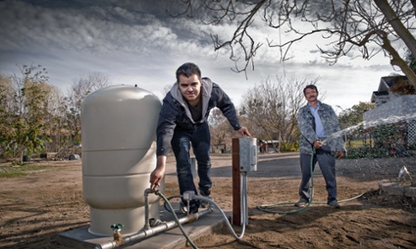 Daniel Arreola and his father Esidronio running the water from their new 110ft well after not having running water for over 6 months.