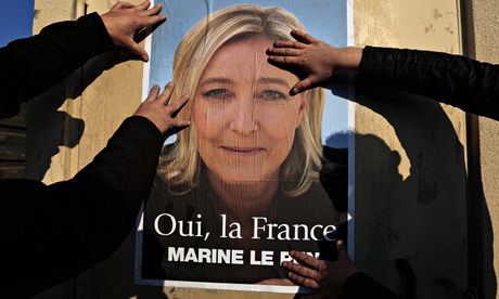 Suppporters put up a poster of Marine Le Pen