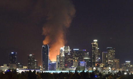 More than 200 Los Angeles firefighters work to control a massive fire that lit up the Los Angeles skyline.