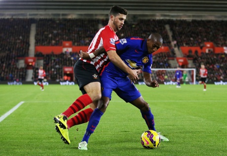 Ashley Young gets his body in the way of Shane Long and the ball.