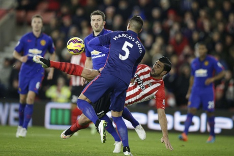 Graziano Pelle tries the spectacular but is closed down by Marcos Rojo.