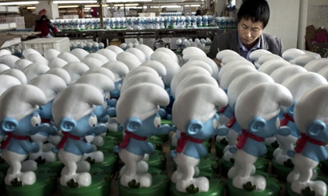 Chinese workers paint unfinished licensed ceramic Smurfs