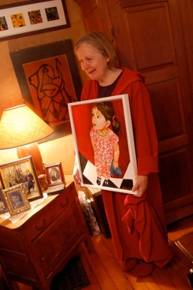 woman holding a painting of her granddaughter