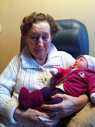 great grandmother holding a baby