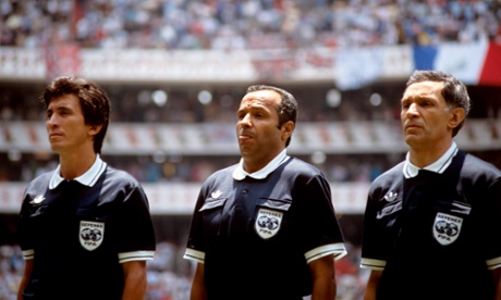 referee Ali Bin Nasser, centre, and linesman Bogdan Dotchev