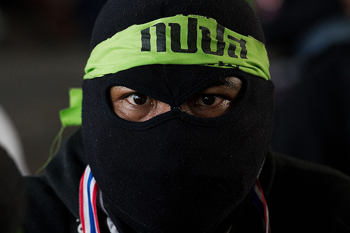 Bangkok Gunfight: A Thai anti-government protester looks on in Bangkok