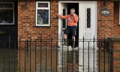 A resident stands at her front door in Wraysbury