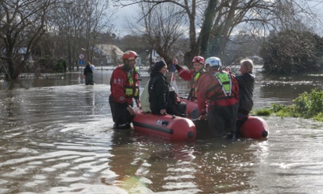 Fire and rescue services ferry residents to safety. With flood waters expected to rise over the next 24 hours the Environment Agency has fourteen severe flood warnings are in place across Berkshire and Surrey.