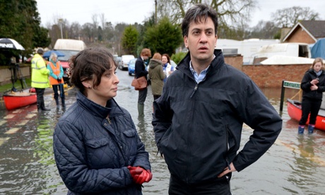 Labour leader Ed Miliband ( and Victoria Groulef (left), Labour's Parliamentary Candidate for Reading West, during a visit to the view recent flooding in Purle- on-Thames in Berkshire.