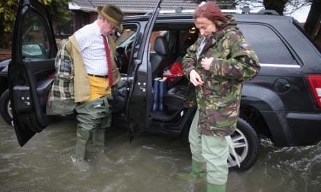 Ukip leader Nigel Farage puts on his waders as he tours flooded properties in Chertsey.