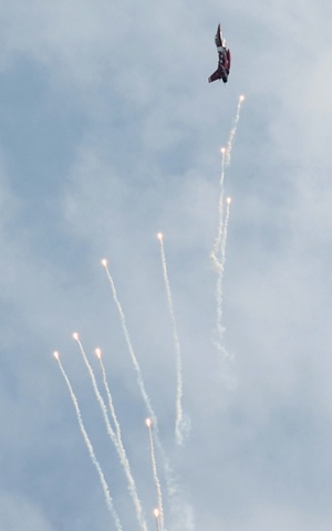 A Republic of Singapore Airforce aircraft releases flares during flying display at the start of Singapore Airshow.