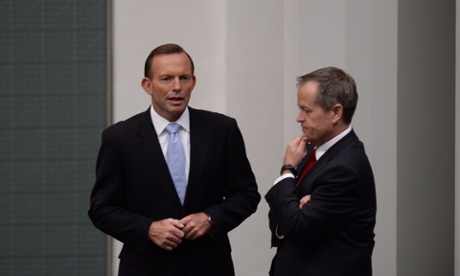 Prime Minister Tony Abbott speaks to Opposition Leader Bill Shorten after announcing the late Corporal Cameron Baird was awarded the 100th Victoria Cross in parliament on Thursday. Image: Lukas Coch for the Guardian.