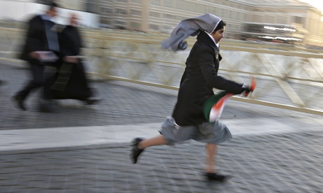 Nun on the run: a nun sprints to a good vantage point in Saint Peter's Square