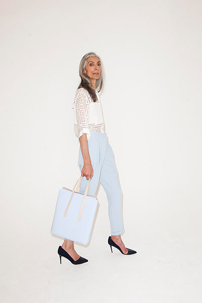 All Ages: pale blue trousers white top high heeled shoes black pale blue bag