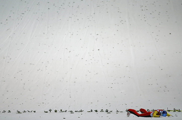 20 Photos: Freund lies in the snow after crashing at the Sochi Winter Olympic Games