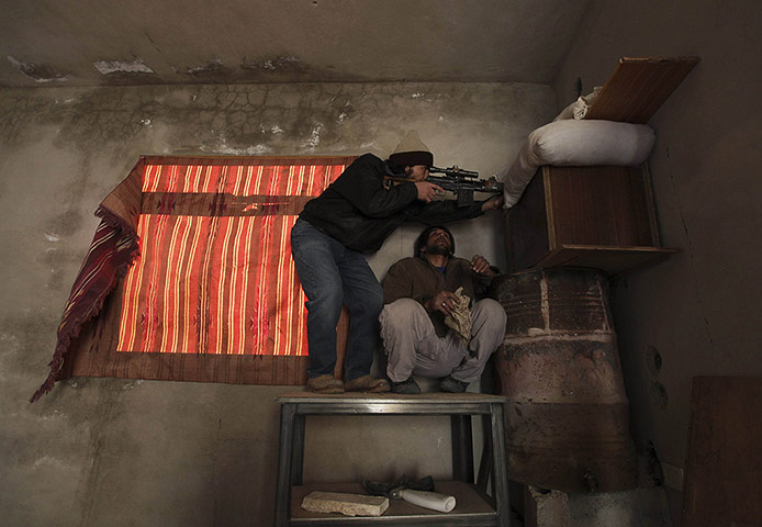 20 Photos: A Free Syrian Army fighter in shooting position in Deir al-Zor, Syria