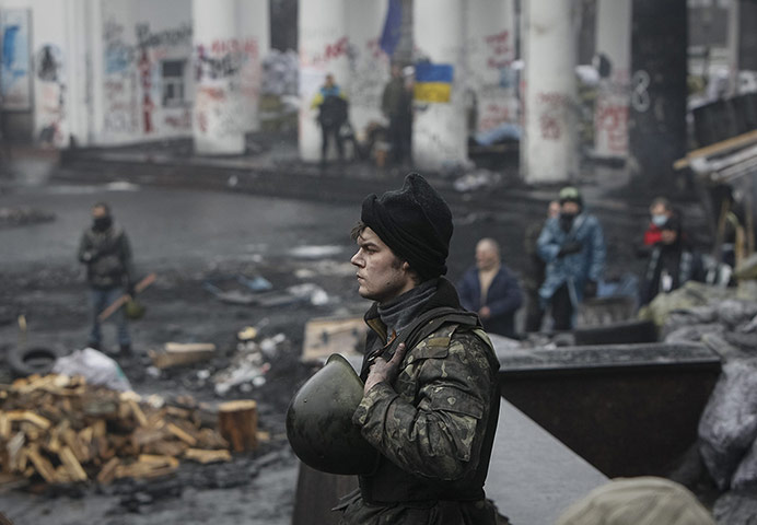 20 Photos: An anti-government protester sings the Ukrainian national anthem in Kiev
