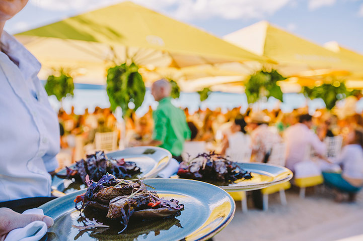 AUSTRALIA ONLINE: A waiter serves food at a crowded outdoor restaurant