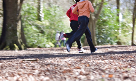 Two people running in a park