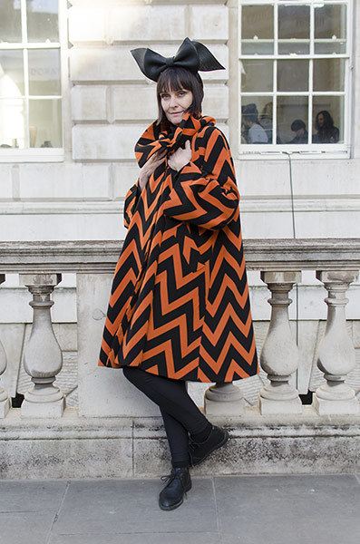 Older Models - Weekend : woman in orange and black coat and black hat