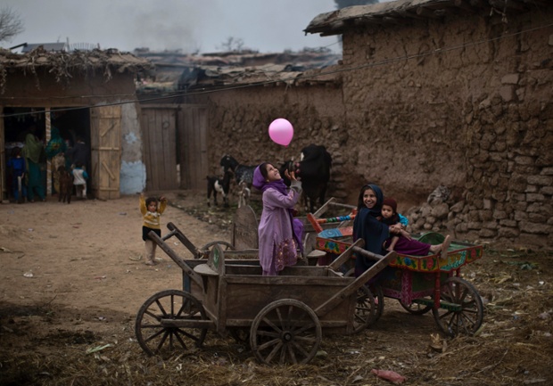 Children play with a balloon in a poor neighbourhood on the outskirts of Islamabad, Pakistan.