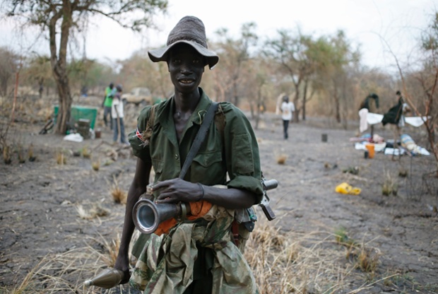 A rebel fighter carries a rocket-propelled grenade in a rebel camp in Jonglei State, South Sudan.